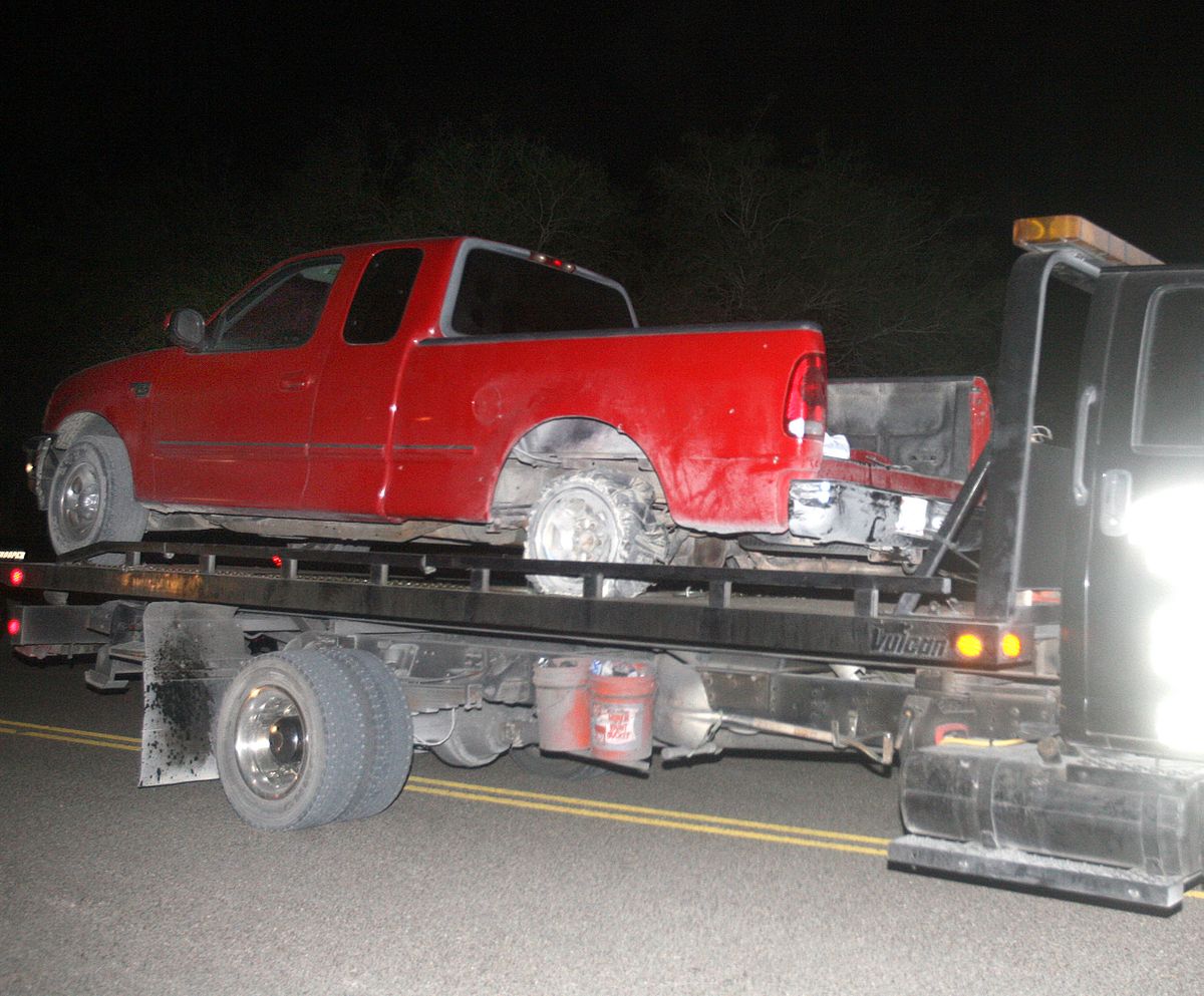 A red pick up truck is moved from the scene of a incident after a chase between law enforcement and suspected human smugglers on 7 mile road north of La Joya, Texas, Thursday, Oct. 25, 2012.  Texas Department of Public Safety sharpshooter opened fire on an evading vehicle loaded with suspected illegal immigrants, leaving at least two people dead, sources familiar with the investigation said.� (Joel Martinez / The Monitor)