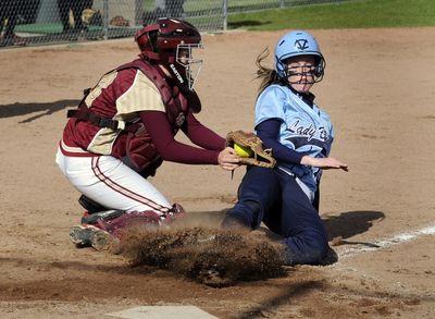 University catcher Alene Bethel tags out Central Valley’s Jamie Belknap at home plate during the fifth inning. (Colin Mulvany / The Spokesman-Review)