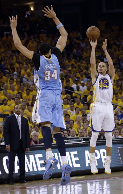 Stephen Curry, shooting over JaVale McGee, led Golden State with 22 points. (Associated Press)