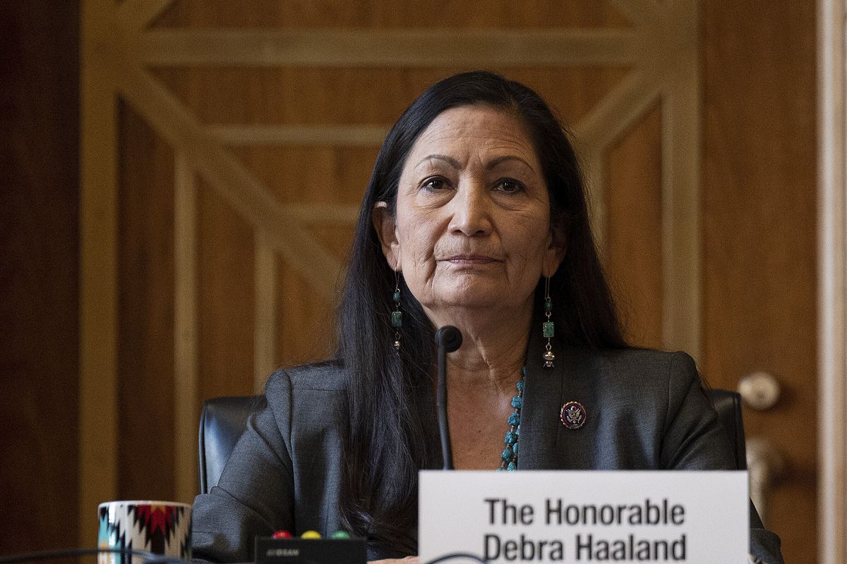 FILE - In this Tuesday, Feb. 23, 2021, file photo, Rep. Deb Haaland, D-N.M., listens during the Senate Committee on Energy and Natural Resources hearing on her nomination to be Interior secretary, on Capitol Hill in Washington. Some Republican senators labeled Haaland "radical" over her calls to reduce dependence on fossil fuels and address climate change, and said that could hurt rural America and major oil and gas-producing states. The label of Haaland as a "radical" by Republican lawmakers is getting pushback from Native Americans.  (Jim Watson)