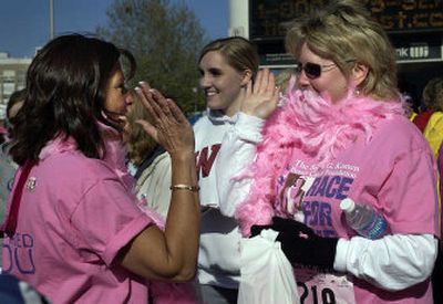 
 Gayle Earling, left, and Andrea Felts give each other a high-five  at the Spokane Convention Center before the start of the first Eastern Washington Race for the Cure on Sunday. Earling and Felts are friends and breast cancer survivors. More than 4,000 people took part in the one-mile and three-mile races. 
 (Liz Kishimoto / The Spokesman-Review)