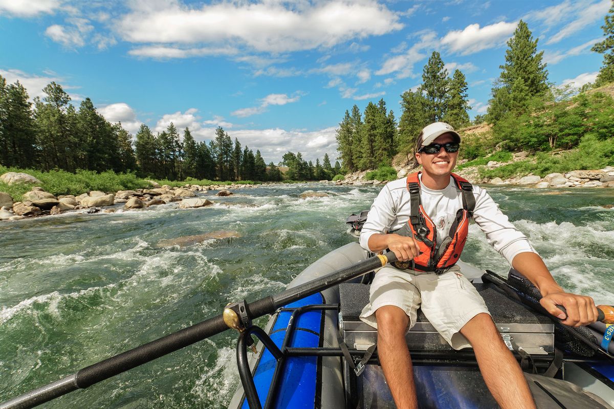 Sean Visintainer of Silver Bow Fly Shop rafts Spokane River rapids.