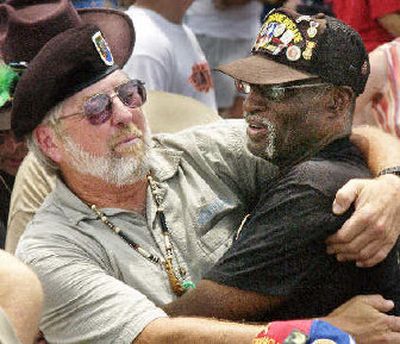 
 Vietnam vets Bruce Bowland, of Gladwin, Mich., left, and J.C. Terry, of Sacramento, Calif., embrace at 