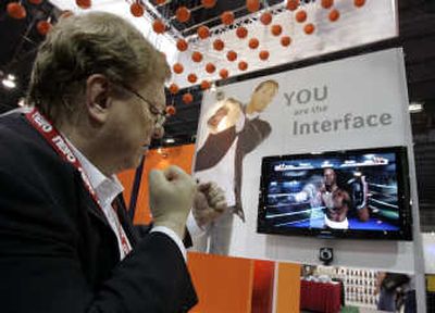 
Attendee Gene Dolgoff plays with 3DV Systems' ZCam boxing game at the CES.
 (Associated Press / The Spokesman-Review)
