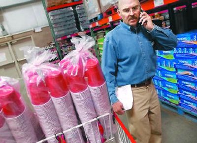 
Jim Hardenbrook of Jumpin' Jimmy's delivery service confirms a needed item with a client while shopping for office supplies in Spokane. 
 (Brian Plonka / The Spokesman-Review)