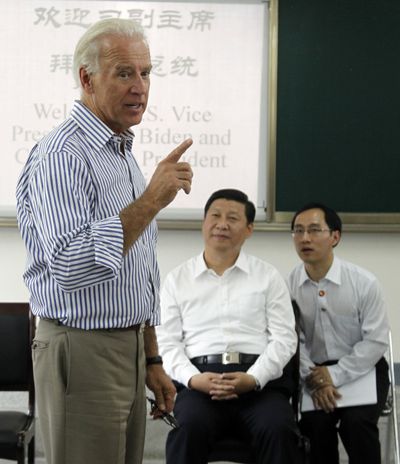 Vice President Joe Biden and Chinese Vice President Xi Jinping, center, visit a high school on Sunday. (Associated Press)