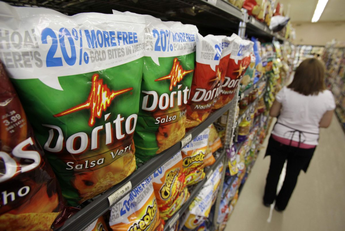 With less money to spend, some consumers are enticed by bigger packages that offer lower per-ounce prices. Doritos, on display in Palo Alto, Calif., now come in 20 percent larger bags.  (Associated Press / The Spokesman-Review)