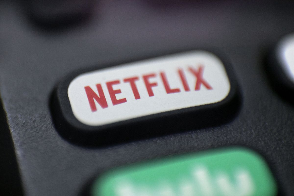 FILE - This Aug. 13, 2020 file photo shows a logo for Netflix on a remote control in Portland, Ore. Streaming services ranging from Netflix to Disney+ want us to stop sharing passwords. That