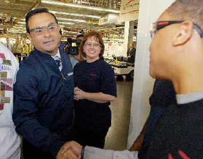 
Carlos Ghosn, left, CEO of Nissan, greets employees during a visit to the Nissan complex in Canton, Miss., on Wednesday.  
 (Associated Press / The Spokesman-Review)