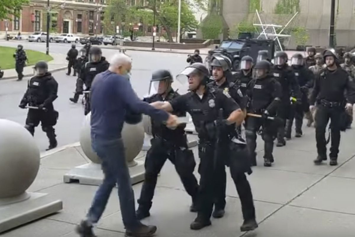 In this image from video provided by WBFO, a Buffalo police officer appears to shove a man who walked up to police Thursday in Buffalo, N.Y. Video from WBFO shows the man hitting (Mike Desmond)