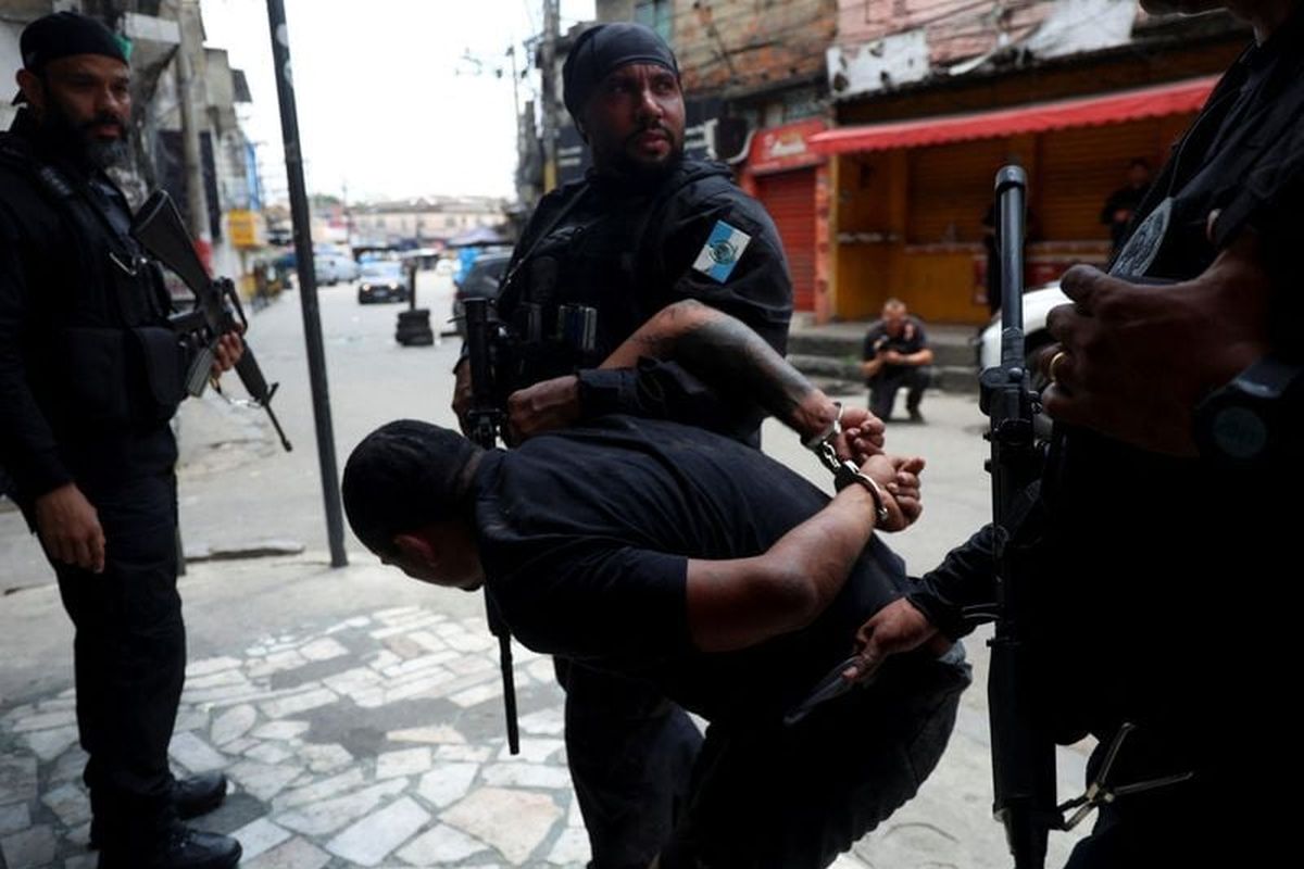 A man is detained by police officers during a police operation against drug trafficking at the favela do Penha, in Rio de Janeiro, Brazil October 28, 2025. (Aline Massuca/Reuters)
