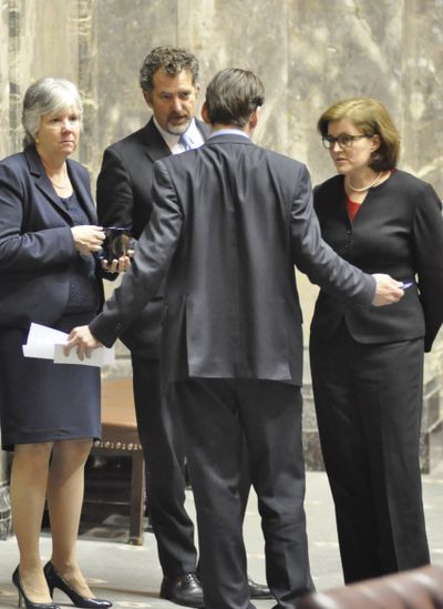 OLYMPIA -- Sen. Andy Billig (center) makes a point to fellow Democratic Sens. Sharon Nelson, Kevin Ranker and Christine Rolfes (left to right) between debate on amendments to the 2015-17 operating budget Thursday evening. (Jim Camden)