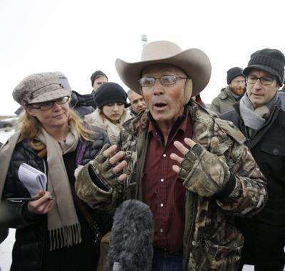 In this Jan. 5, 2016 file photo, Robert “LaVoy” Finicum, center, a rancher from Arizona, talks to reporters at the Malheur National Wildlife Refuge near Burns, Ore. On Tuesday, March 8, 2016, authorities said police were justified in killing Finicum during a traffic stop on Jan. 26, 2016. (AP Photo/Rick Bowmer, file)