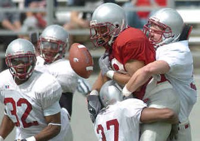 
WSU wide receiver Trandon Harvey loses the ball near the goal line after being sandwiched by the Cougars' defense. 
 (Joe Barrentine / The Spokesman-Review)