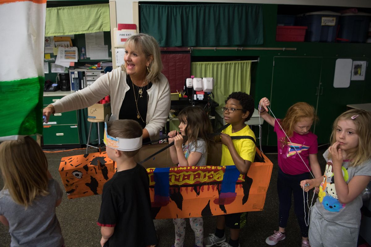 Debra Halstead guides students during an all school assembly before their annual field day on Wednesday, June 13, 2018, at Garfield Elementary in Spokane, Wash. Debra Halstead is retiring from Garfield Elementary after 31 years of teaching. (Tyler Tjomsland / The Spokesman-Review)