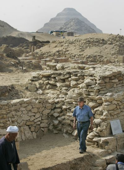 Antiquities chief Zahi Hawass walks around the site of a newly-discovered pyramid, the base of which is seen at center, at Saqqara near Cairo.  (Associated Press / The Spokesman-Review)