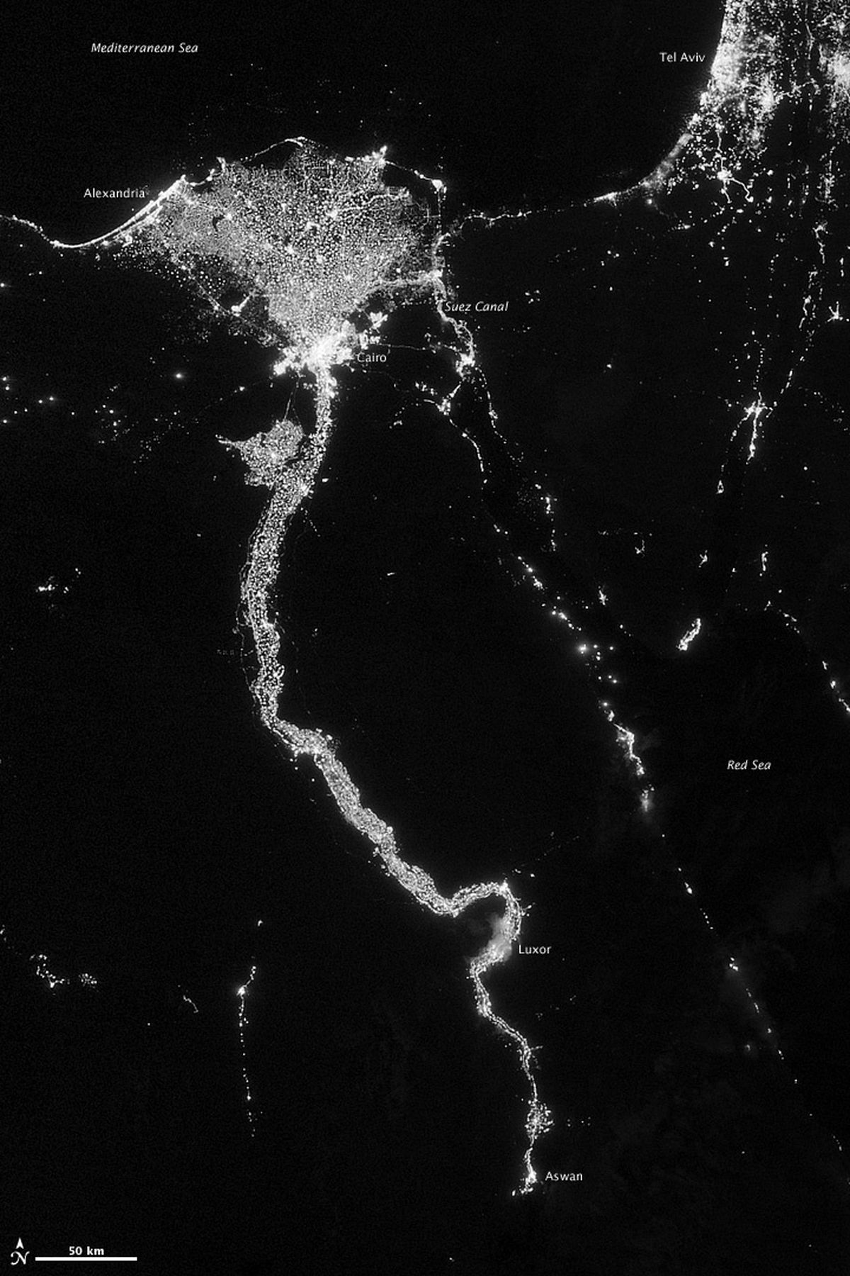 In this image from Oct. 13, 2012 provided by NASA, the Nile River valley and delta is seen at night from a composite assembled from data acquired by the Suomi NPP satellite. The image was made possible by the new satellite�s �day-night band� of the Visible Infrared Imaging Radiometer Suite (VIIRS), which detects light in a range of wavelengths from green to near-infrared and uses filtering techniques to observe dim signals such as city lights, gas flares, auroras, wildfires, and reflected moonlight. The Nile River Valley and Delta comprise less than 5 percent of Egypt�s land area, but provide a home to roughly 97 percent of the country�s population. Nothing makes the location of human population clearer than the lights illuminating the valley and delta at night. The city lights resemble a giant calla lily, just one with a kink in its stem near the city of Luxor. Some of the brightest lights occur around Cairo, but lights are abundant along the length of the river. Bright city lights also occur along the Suez Canal and around Tel Aviv. Away from the lights, however, land and water appear uniformly black. This image was acquired near the time of the new Moon, and little moonlight was available to brighten land and water surfaces. (Nasa)