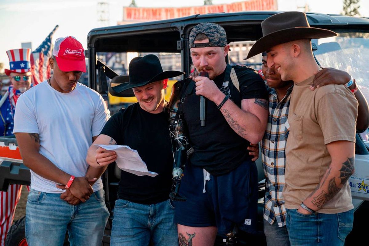 Folsom’s hometown hero U.S. Marine Sergeant Tyler Vargas-Andrew, center, is joined by some of his Marine Corps “Brothers in Arms,” Christian Ritter, Daulton Hannigan, Caden Cooper, and Jorge Mayo, as he addresses the crowd at the Folsom Pro Rodeo on Sunday. Hannigan, Cooper, and Mayo served in his unit in Kabul. The ceremony honored the 13 U.S. service members killed and 18 Marines that were seriously wounded at the Kabul airport bombing in Afghanistan, including Vargas-Andrews.  (Lezlie Sterling/The Sacramento Bee/TNS)