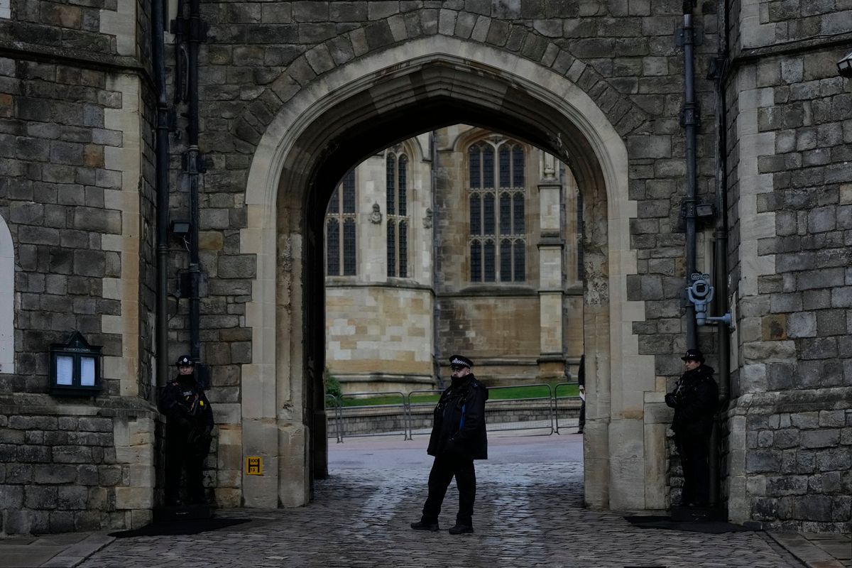 Police guard the Henry VIII gate at Windsor Castle at Windsor, England on Christmas Day, Saturday, Dec. 25, 2021. Britain’s Queen Elizabeth II has stayed at Windsor Castle instead of spending Christmas at her Sandringham estate due to the ongoing COVID-19 pandemic.  (Alastair Grant)