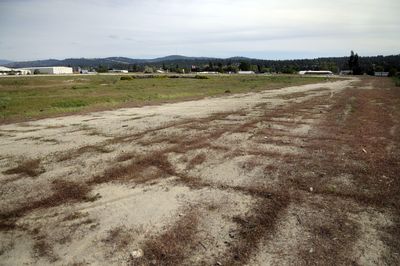 Weeds grow in what remains of the former Playfair racetrack in east Spokane. The city is poised to sell Playfair for less than it paid – $6.3 million in 2004 – after two rounds of bidding.  (Colin Mulvany / The Spokesman-Review)