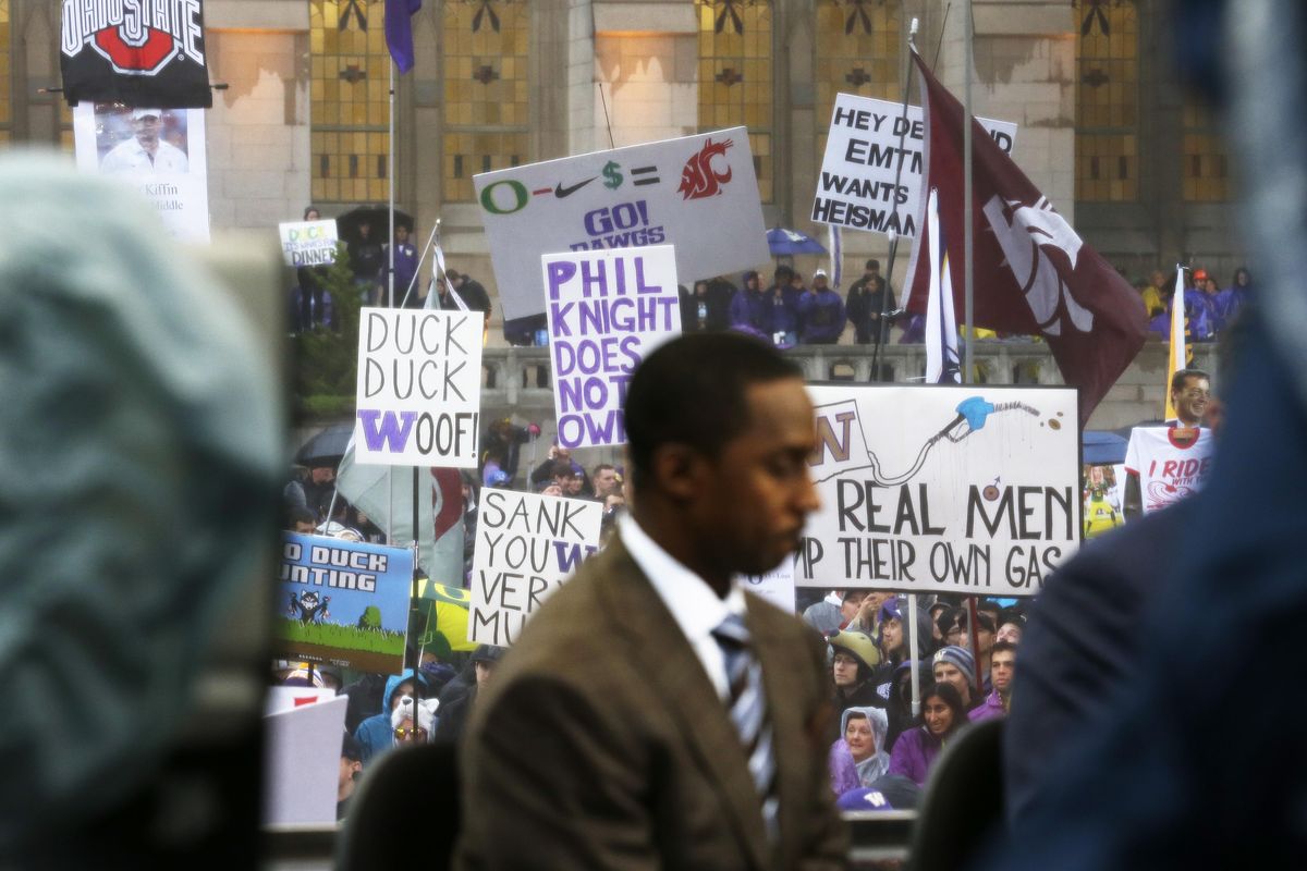 The Washington State Cougars flag is waved at upper right above ESPN College GameDay co-host Desmond Howard, Saturday, Oct. 12, 2013, during College GameDay