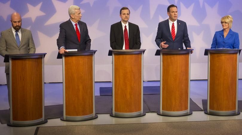 Russ Fulcher, third from right, speaks during a debate at the studios of Idaho Public Television in Boise on April 29, 2018, as five of his rivals for the GOP nomination for an open Idaho congressional seat look on. From left are Luke Malek, David Leroy, and Michael Snyder; from right are Alex Gallegos and Christy Perry. Not pictured is Nick Henderson, who didn’t participate in the debate. (Otto Kitsinger / AP)