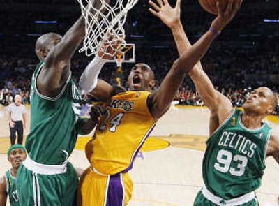 
Kobe Bryant drives to the basket between Boston's Kevin Garnett, left, and P.J. Brown during Tuesday night's Los Angeles win. Associated Press
 (Associated Press / The Spokesman-Review)