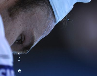 Beads of sweat drip from the forehead of Andy Roddick of the United States during a break in his game against Marin Cilic of Croatia during their Men's singles quarterfinal match at the Australian Open tennis championship in Melbourne, Australia, Monday Jan. 25, 2010. (Andy Wong / Associated Press)