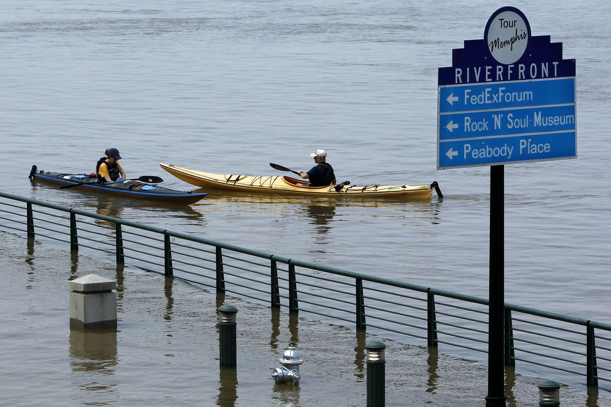 Kayakers paddle the Mississippi River floodwaters near the base of Beale Street on Sunday in Memphis, Tenn. (Associated Press)