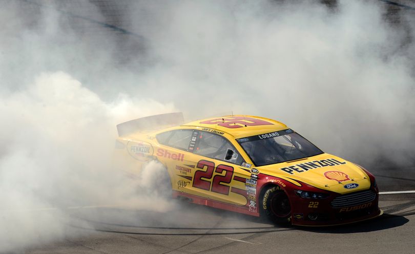 Joey Logano, driver of the #22 Shell-Pennzoil Ford, celebrates with a burnout after winning the NASCAR Sprint Cup Series 44th Annual Pure Michigan 400 at Michigan International Speedway on August 18, 2013 in Brooklyn, Michigan. (Photo Credit: Jared C. Tilton/NASCAR via Getty Images) (Jared Tilton / Getty Images North America)