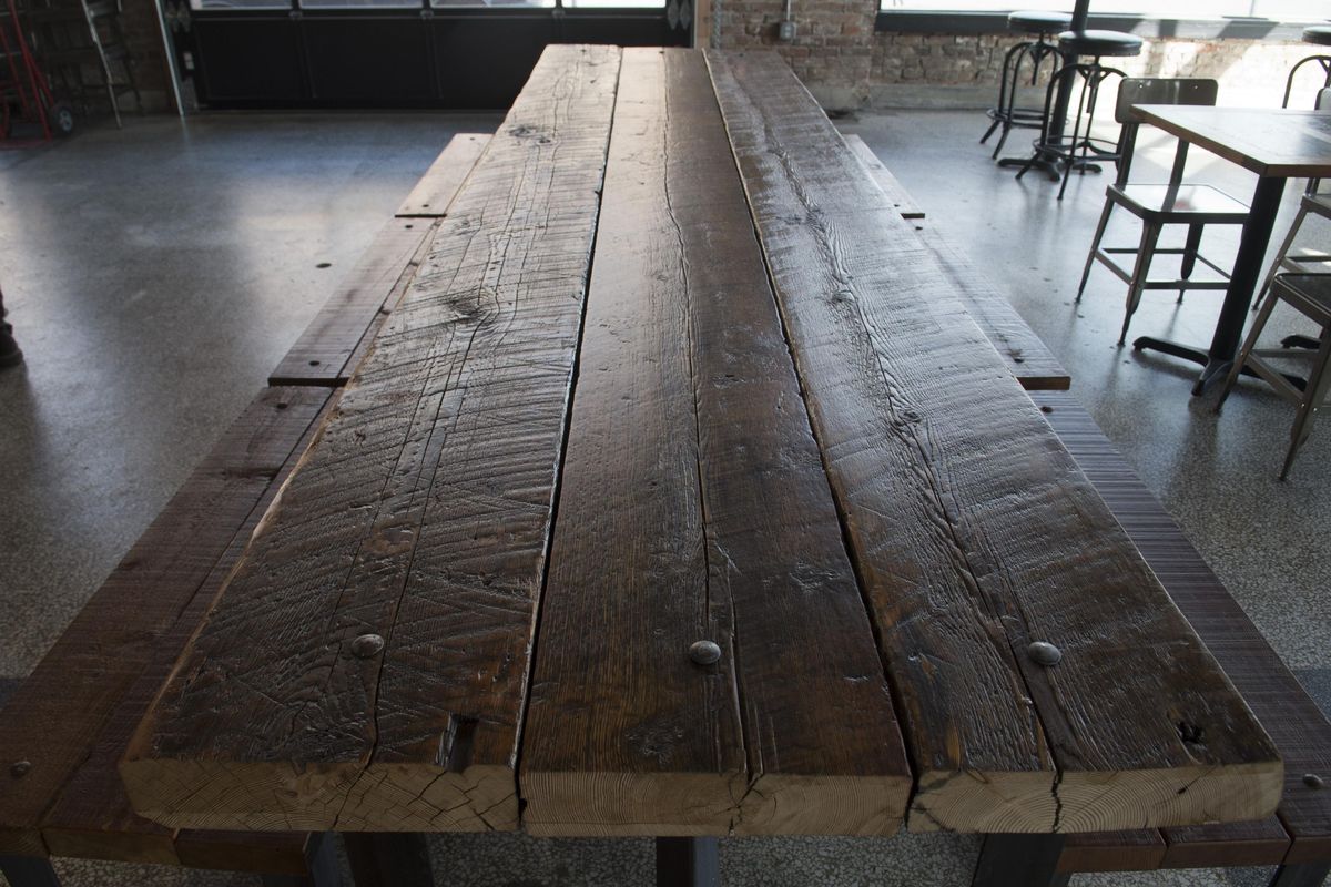 The owners of Iron Goat Brewing Co.,  have preserved the industrial interior of the former shop with rustic furniture, shown Tuesday, April 5, 2016. (Jesse Tinsley / The Spokesman-Review)