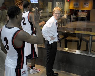 Demetri Goodson and coach Mark Few watch a replay of the winning shot.  (Christopher Anderson / The Spokesman-Review)