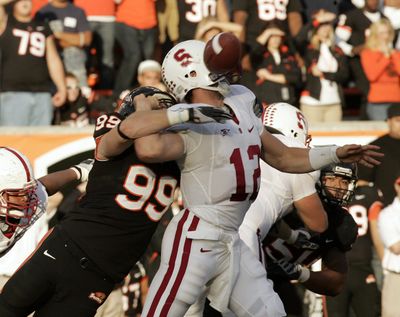 Oregon State defender Gabe Miller, left, forces Stanford quarterback Andrew Luck to fumble. (Associated Press / The Spokesman-Review)