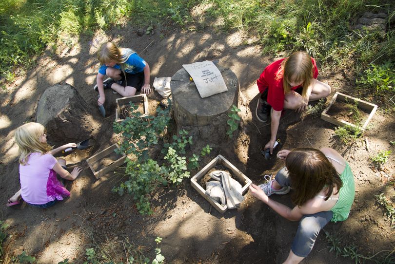 From left, triplets, Kaitlin, Briana and Ashleigh Creeger, 11, and Jenna Fonteyne, 10, dig for quartz and fluorite crystals, agate, obsidian, petrified wood and more at Livingstone’s Rock Ranch Friday. (Colin Mulvany)