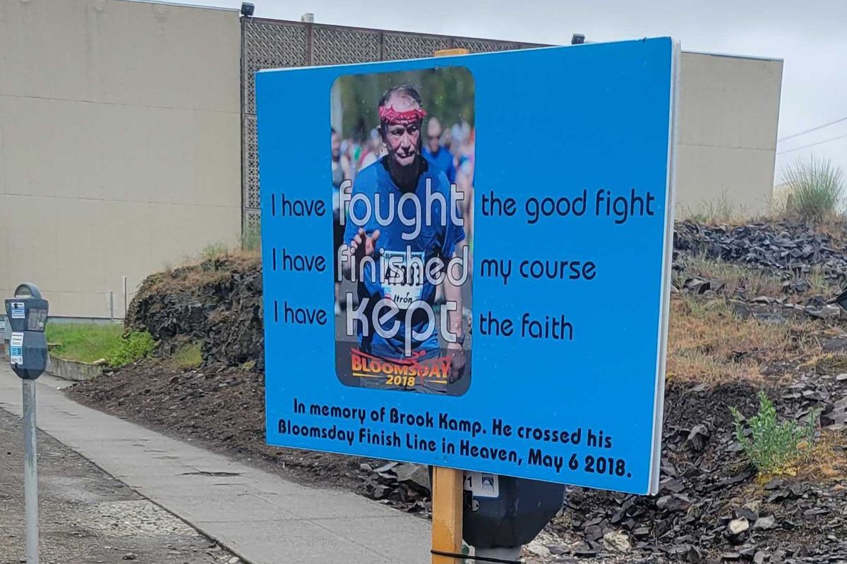 Brook Kamp died of a heart attack while racing in Bloomsday 2018. Each year, his daughter Mindy Rowe and her family erect a memorial at the spot that he passed, near the corner of Adams Street and Broadway Avenue.  (Nick Gibson/The Spokesman-Review)