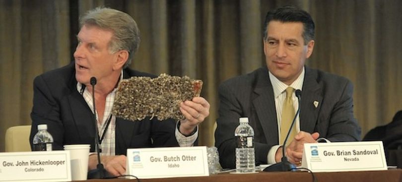 Idaho Gov. Butch Otter brandishes a quagga mussel-encrusted license plate at a Western Governors Association meeting in Las Vegas. (WGA)