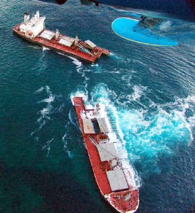 This Coast Guard photo shows the two halves of the Selendang Ayu last week.
(Associated Press / The Spokesman-Review)