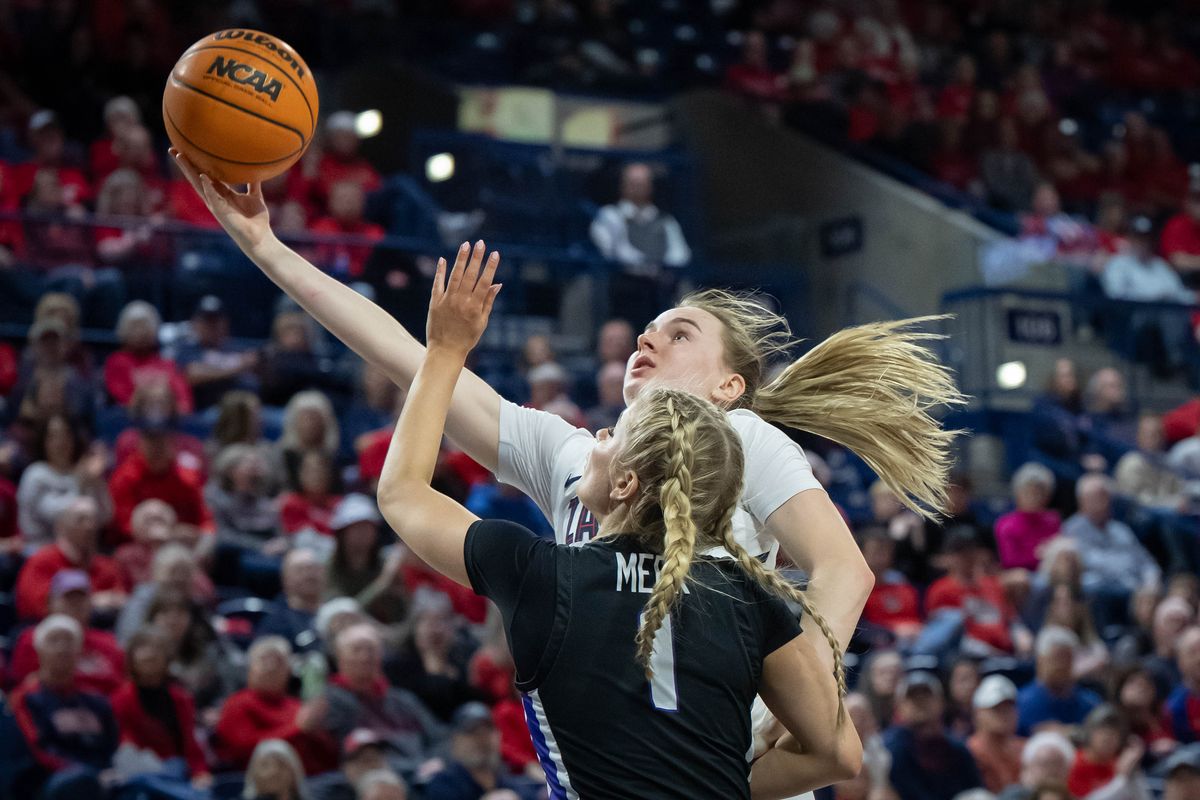 Gonzaga guard Brynna Maxwell (22) shoots the ball underhanded as Portland guard McKelle Meek (1) defends during the first half of a NCAA college basketball game, Wednesday, Feb. 28, 2024, in the McCarthey Athletic Center.  (COLIN MULVANY)