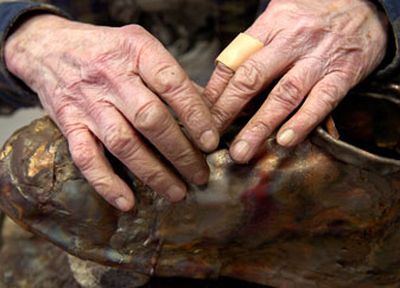 
Sister Paula Turnbull works on the shoelaces for the memorial sculpture of Mike Cmos Jr. The sculpture is scheduled to be complete in August 2006. 
 (Holly Pickett / The Spokesman-Review)