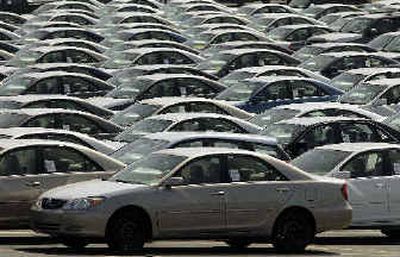 
New Toyota cars await train shipping to their final U.S. destination at the Toyota Logistics parking lot at the Long Beach Port in Long Beach, Calif. 
 (Associated Press / The Spokesman-Review)