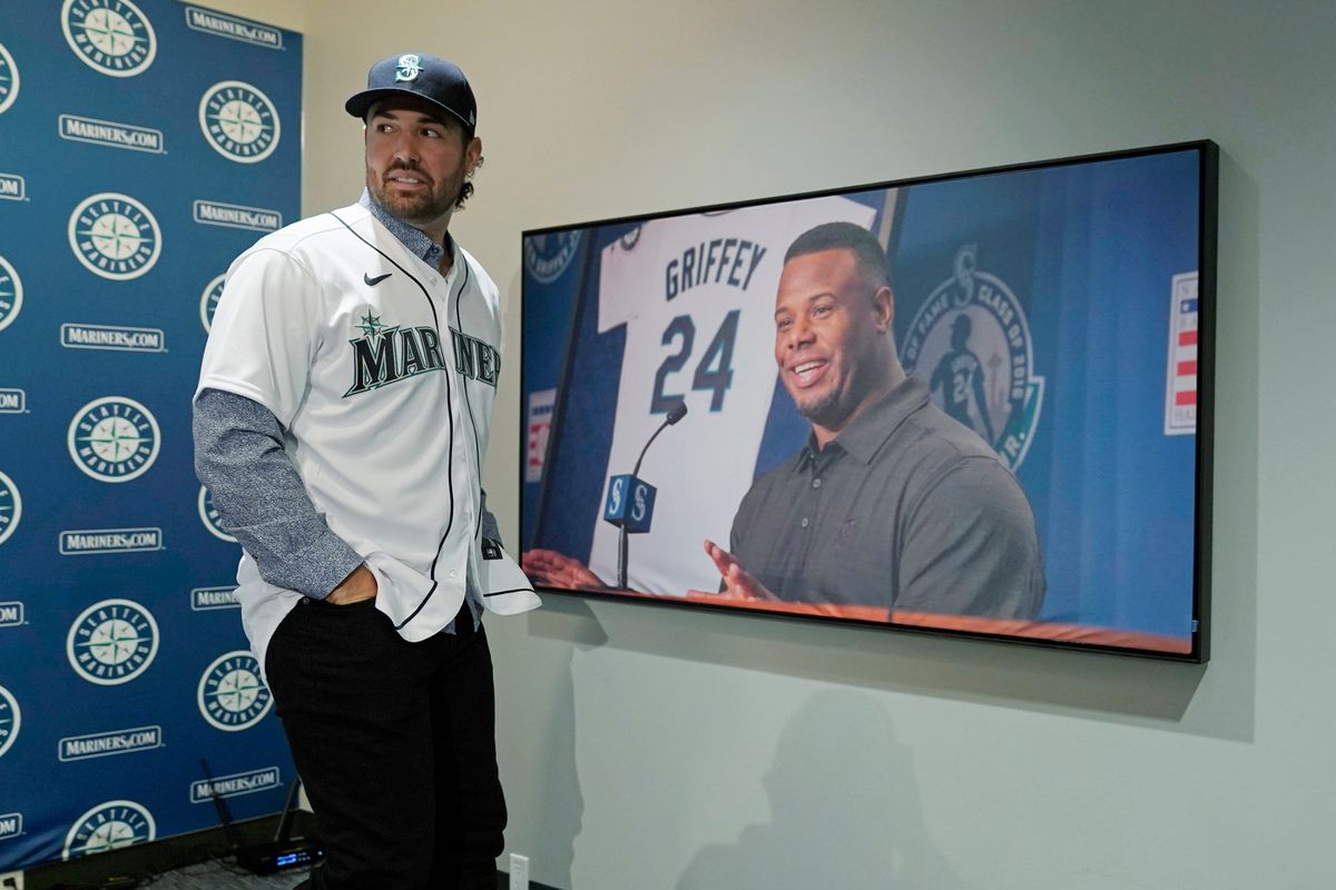 Newly signed Seattle Mariners pitcher Robbie Ray walks past a photo of Hall-of-Famer Ken Griffey Jr. on Wednesday following a news conference in Seattle. (Ted S. Warren)