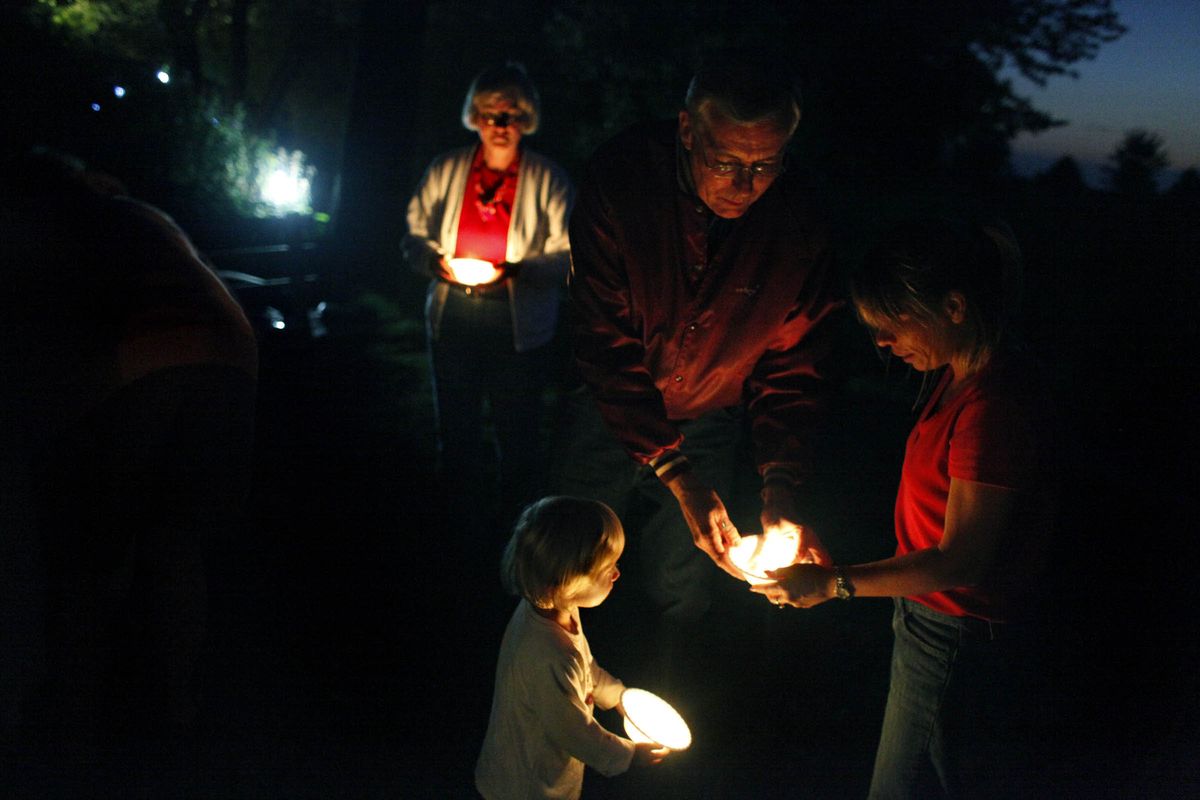 Bruce Conley lights candles with people who are grappling with the loss of loved ones during a recent “Fire and Rain” remembrance event in Elburn, Ill. McClatchy-Tribune (McClatchy-Tribune / The Spokesman-Review)