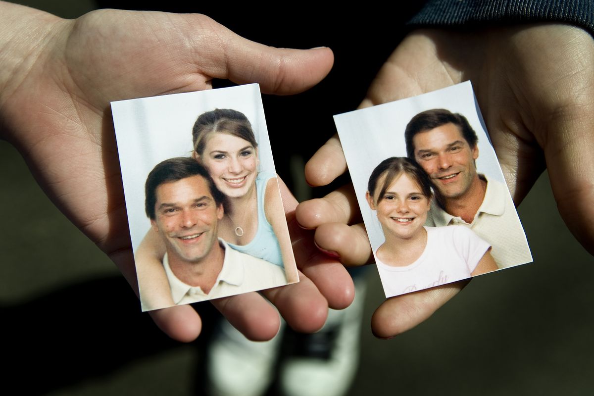 Douglas Klages’ daughters  hold  recent photos of them  with their dad, who was found dead Friday. At left is Erika Klages, 19, and at right is 14-year-old Racheal Rydell-Klages. (Colin Mulvany)