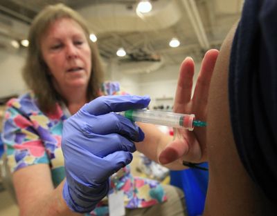 Nurse Susan Peel gives a whooping cough vaccination to a student at Inderkum High School on Monday in Sacramento, Calif. (Associated Press)
