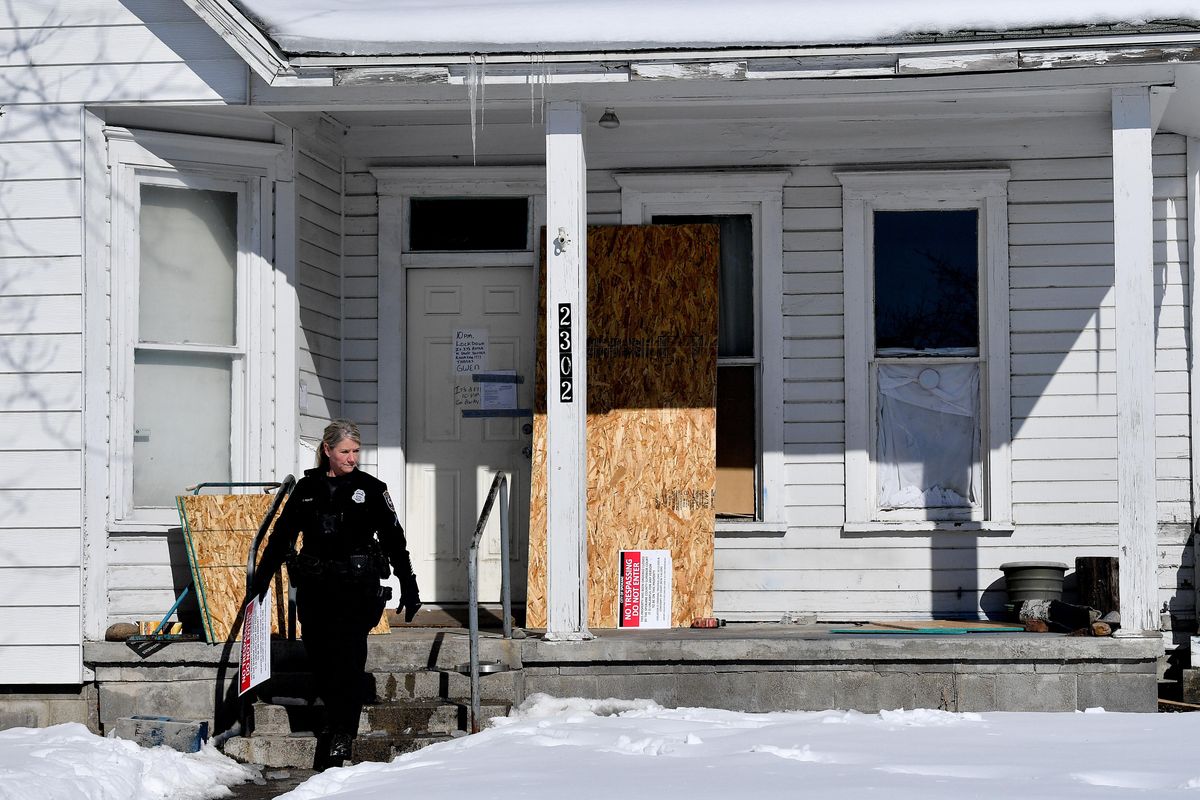 Officer Traci Ponto walks out from a home officers vacated at 2302 W. College Avenue on Monday, March 4, 2019, in Spokane, Wash. (Tyler Tjomsland / The Spokesman-Review)