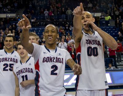 Gonzaga seniors Marquise Carter (2) and Robert Sacre (00) thank Bulldogs fans after their McCarthey Athletic Center finale Monday night. (Colin Mulvany)
