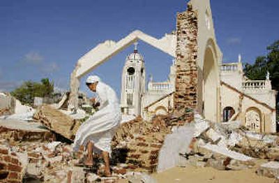 
Sister Ambrose, a Sri Lankan nun, looks through the rubble of a church in Mullaitivu,  in northern Sri Lanka. 
 (Associated Press / The Spokesman-Review)