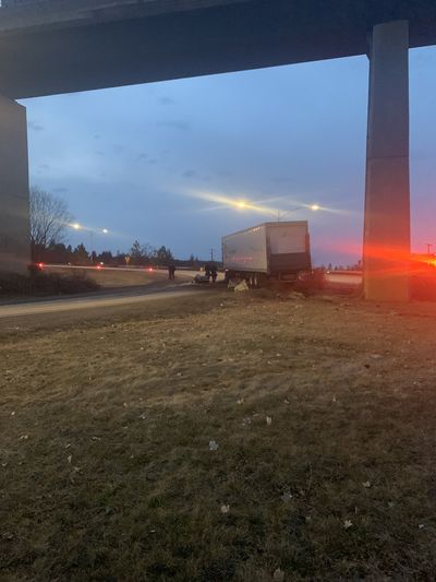 A semi is pictured after it crashed off Interstate 90 at the exit to U.S. Route 195 and spilled 100 gallons of diesel Monday, March 20, 2023.  (Washington State Patrol)