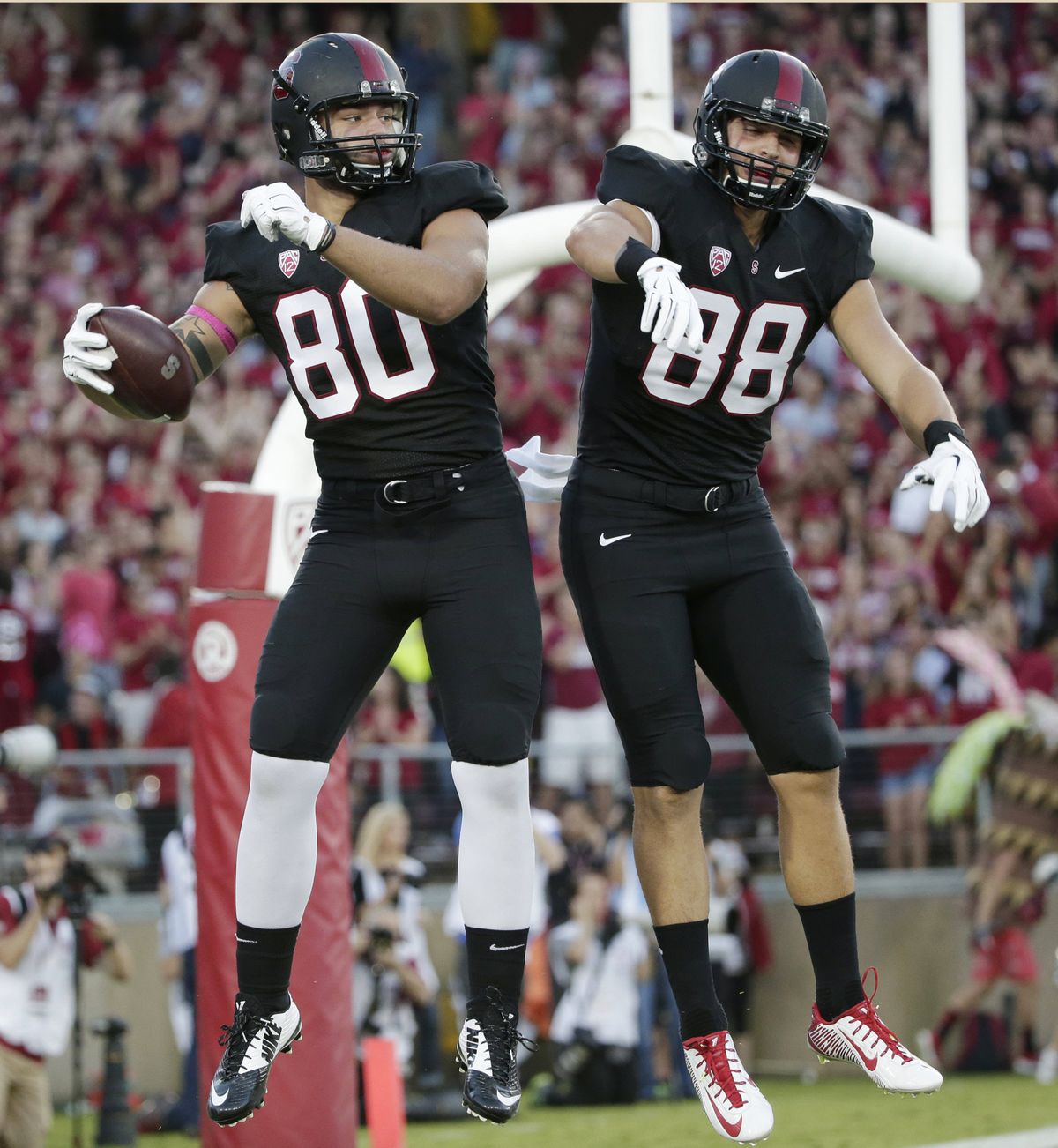 Stanford tight end Eric Cotton, left, celebrates his TD with Greg Taboada. (Associated Press)
