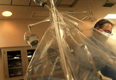 
Sacred Heart Hospital cardiovascular technologist Rick Rowbotham prepares a patient for surgery in Spokane. 
 (Brian Plonka / The Spokesman-Review)